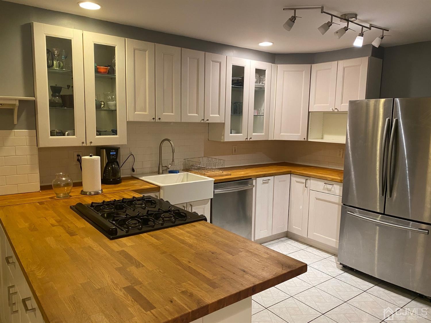 332 New Market Road Dunellen, NJ 08812 - Photo 4 of 16 a kitchen with stainless steel appliances granite countertop a sink stove and refrigerator