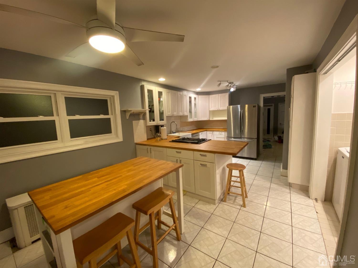 332 New Market Road Dunellen, NJ 08812 - Photo 5 of 16 a kitchen with a table and chairs in it