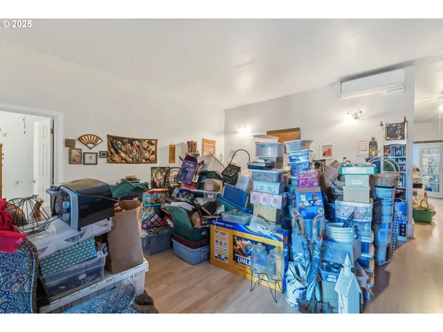a living room with lots of furniture and clutter