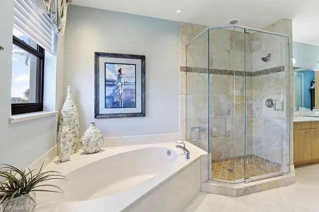 a bathroom with a bathtub and a shower