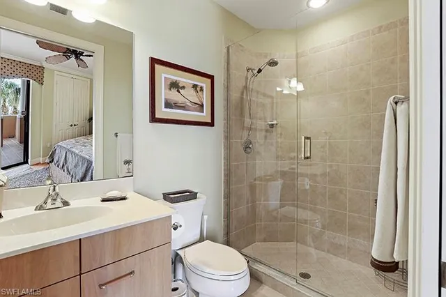 a bathroom with a sink toilet a mirror and shower