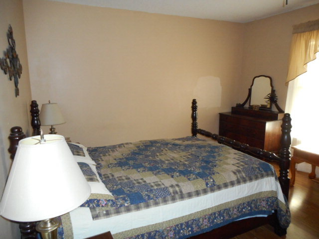 734 Joe Barnes Road Byron, GA 31008 - Photo 8 of 24 a bedroom with a bed and a mirror