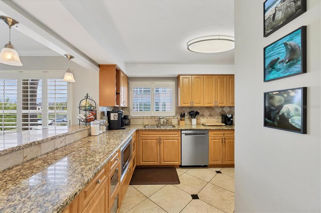 11000 Placida Road, Unit 1601 Placida, FL 33946 - Photo 13 of 58 a large kitchen with a stove a sink dishwasher and cabinets
