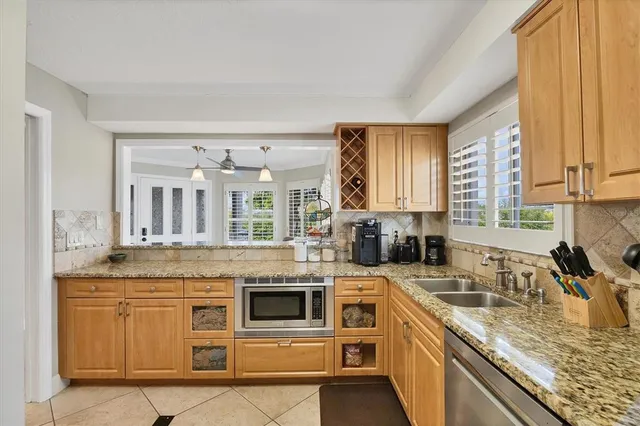 a kitchen with stainless steel appliances granite countertop a stove and a sink