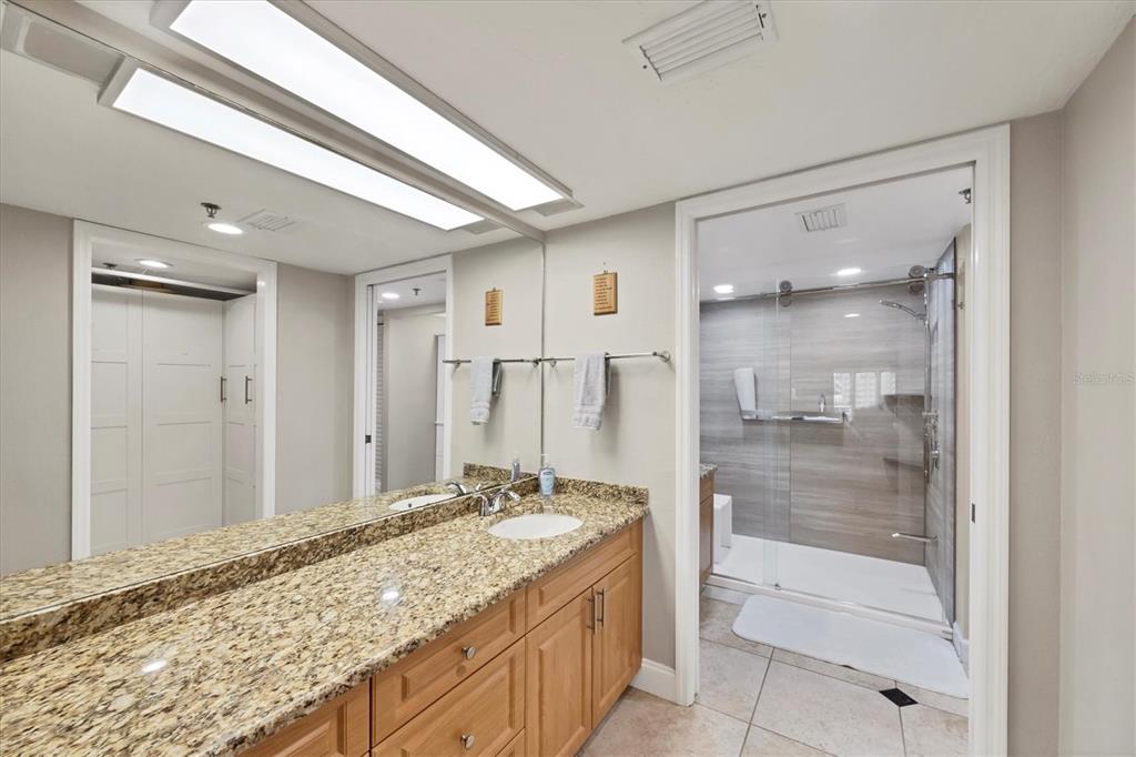 11000 Placida Road, Unit 1601 Placida, FL 33946 - Photo 21 of 58 a bathroom with a granite countertop sink and a mirror