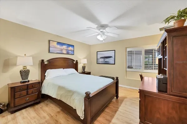 a view of a street with benches and buildings in the background