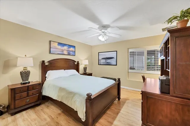 a bathroom with a granite countertop sink a toilet a mirror and vanity