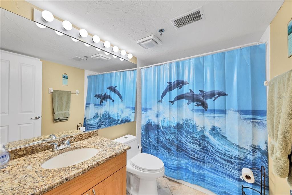 11000 Placida Road, Unit 1601 Placida, FL 33946 - Photo 25 of 58 a bathroom with a granite countertop sink a toilet a mirror and vanity