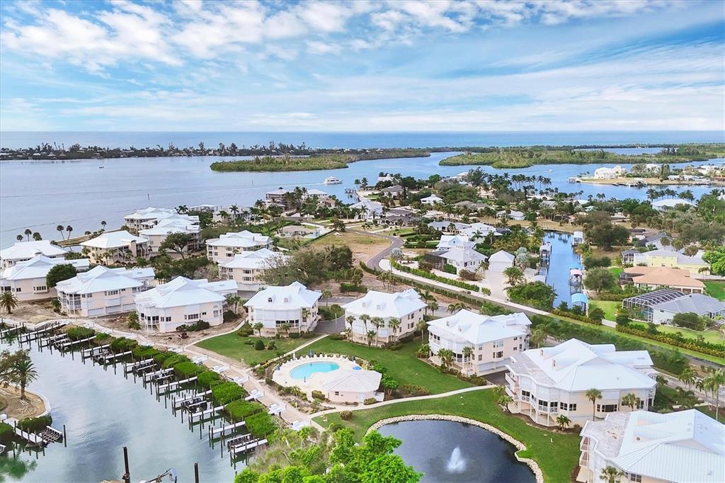 11000 Placida Road, Unit 1601 Placida, FL 33946 - Photo 27 of 58 an aerial view of a city with lots of residential buildings ocean and mountain view in back