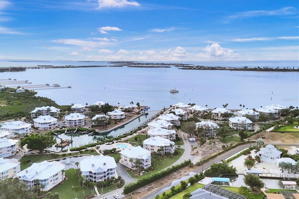 11000 Placida Road, Unit 1601 Placida, FL 33946 - Photo 31 of 58 an aerial view of a city with lots of residential buildings ocean and mountain view in back