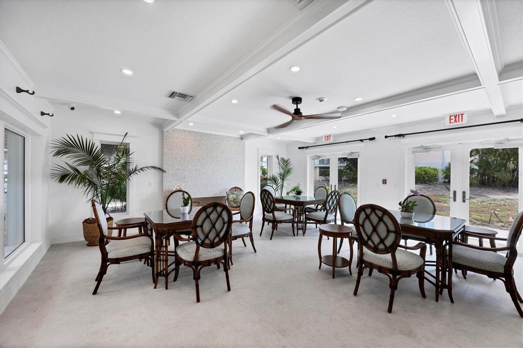 11000 Placida Road, Unit 1601 Placida, FL 33946 - Photo 37 of 58 a view of a dining room and livingroom with furniture a rug a fireplace and a chandelier