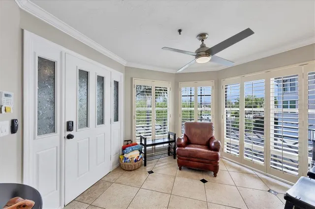 a living room with furniture and large windows