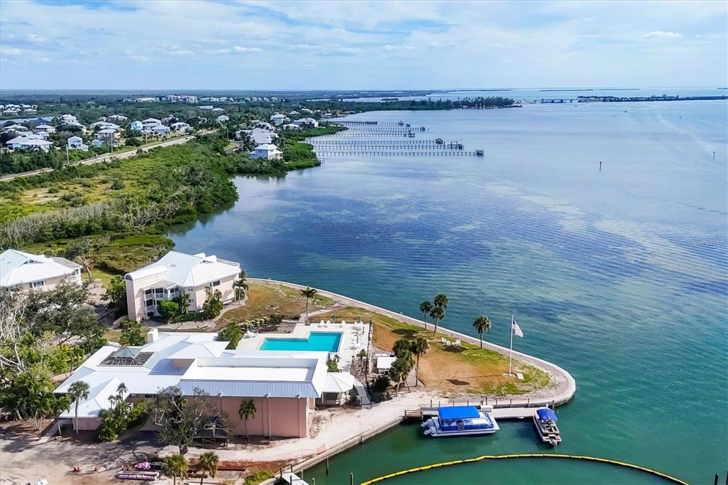11000 Placida Road, Unit 1601 Placida, FL 33946 - Photo 45 of 58 an aerial view of a house with a garden and lake view