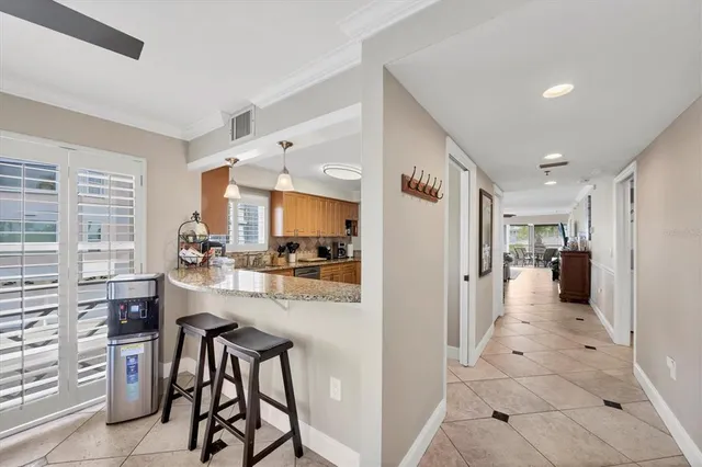 a view of a kitchen with kitchen island cabinets and refrigerator