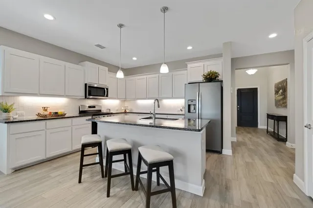 a kitchen with center island table and chairs