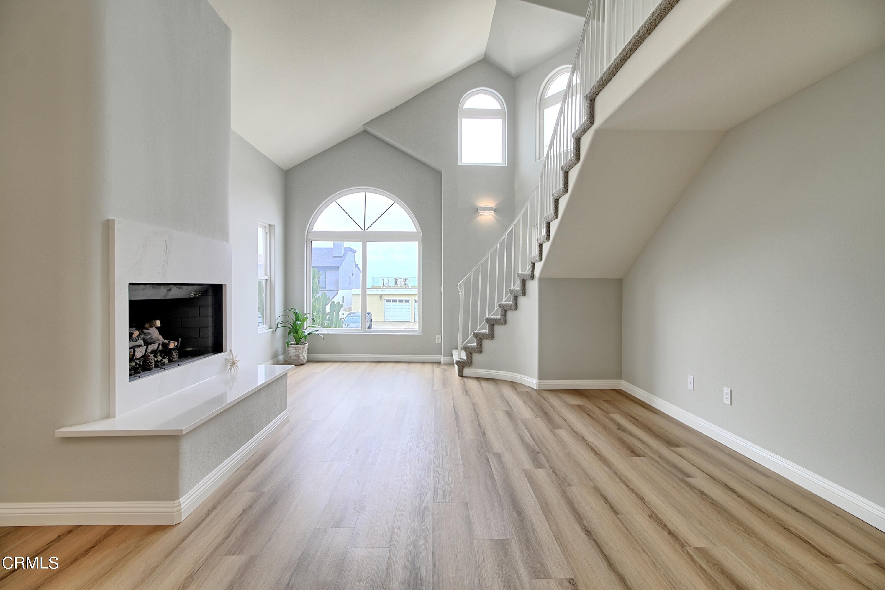 1516 Ocean Drive Oxnard, CA 93035 - Photo 5 of 42 a view of an empty room with wooden floor fireplace and a window