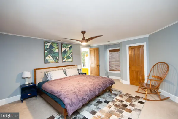 a living room with a furniture a rug and a window