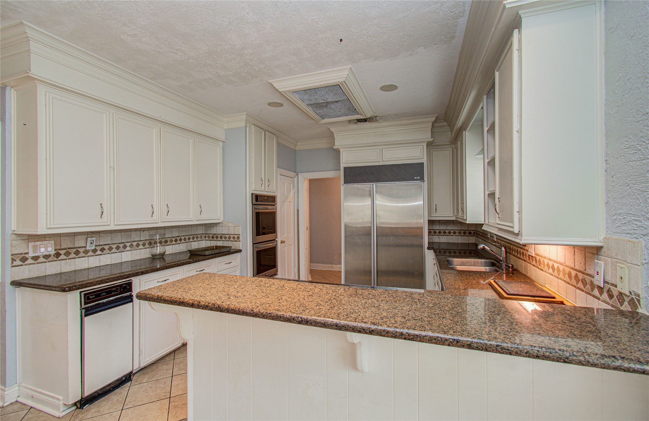8103 Oak Moss Drive Spring, TX 77379 - Photo 13 of 33 a kitchen with stainless steel appliances granite countertop a sink and a refrigerator