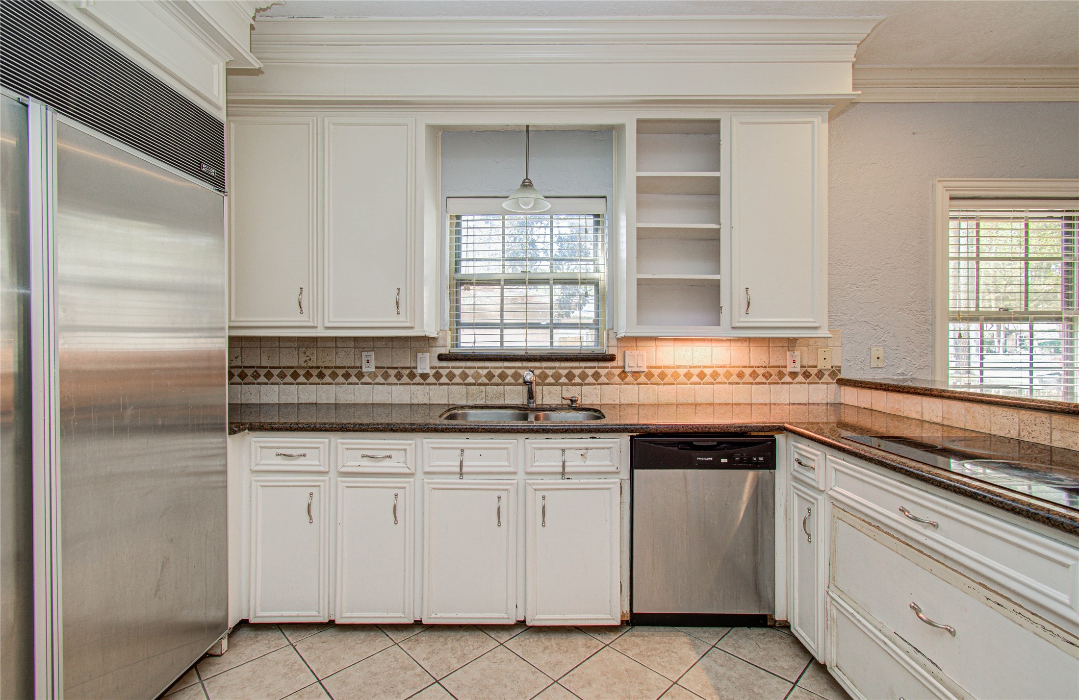 8103 Oak Moss Drive Spring, TX 77379 - Photo 14 of 33 a kitchen with white cabinets and sink