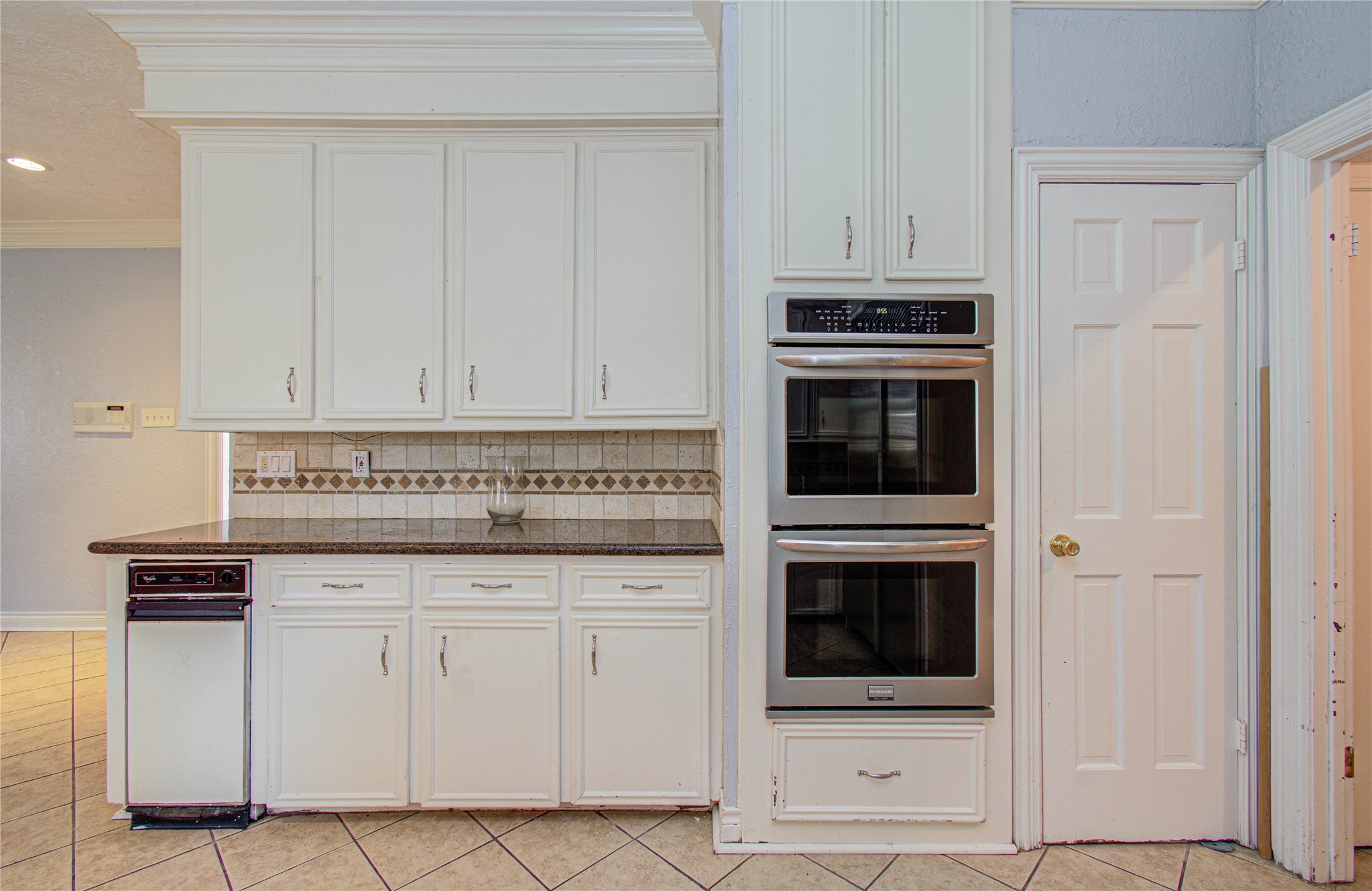 8103 Oak Moss Drive Spring, TX 77379 - Photo 15 of 33 a kitchen with granite countertop white cabinets and stainless steel appliances