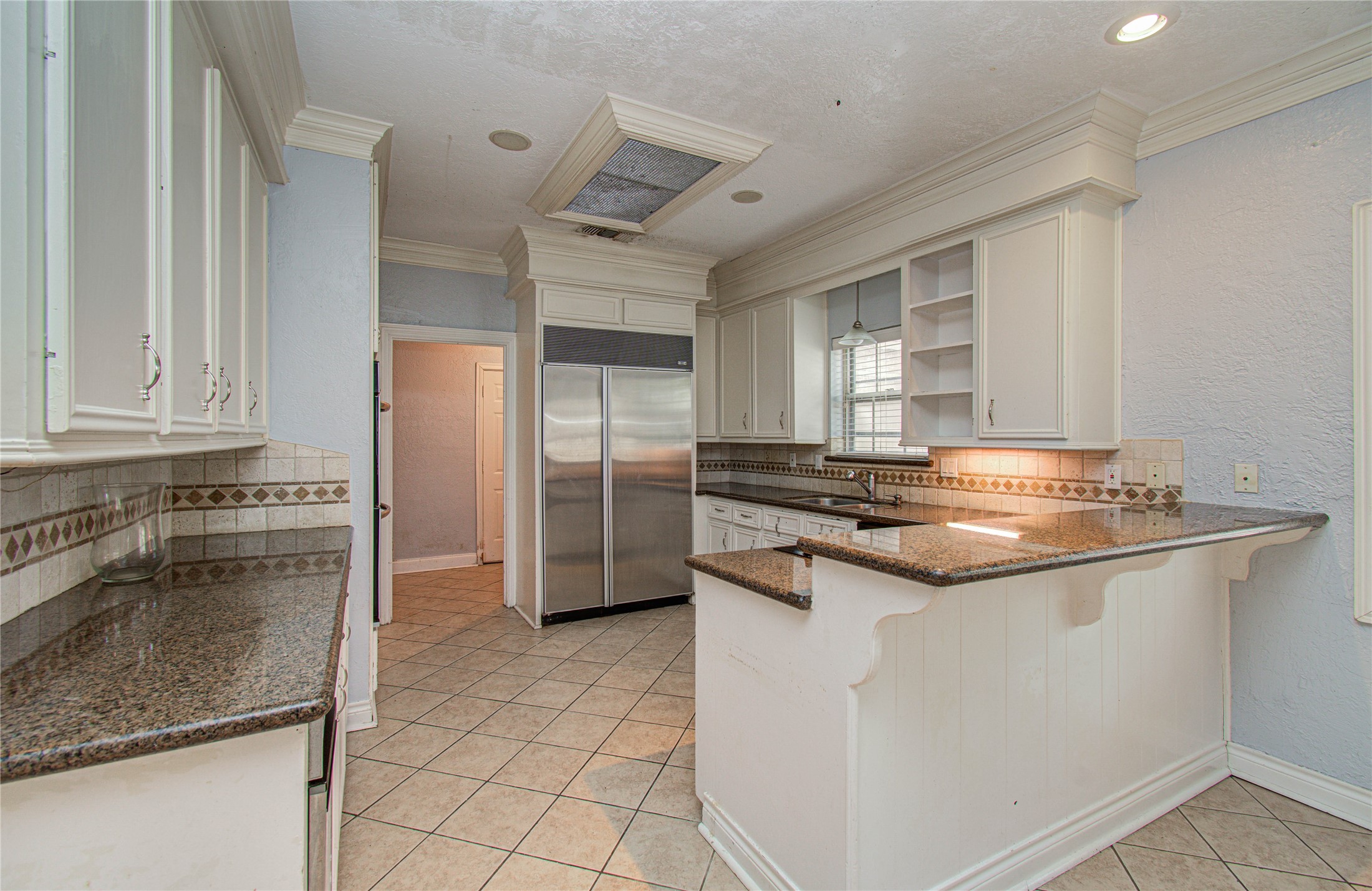8103 Oak Moss Drive Spring, TX 77379 - Photo 16 of 33 a kitchen with stainless steel appliances granite countertop a sink and a refrigerator