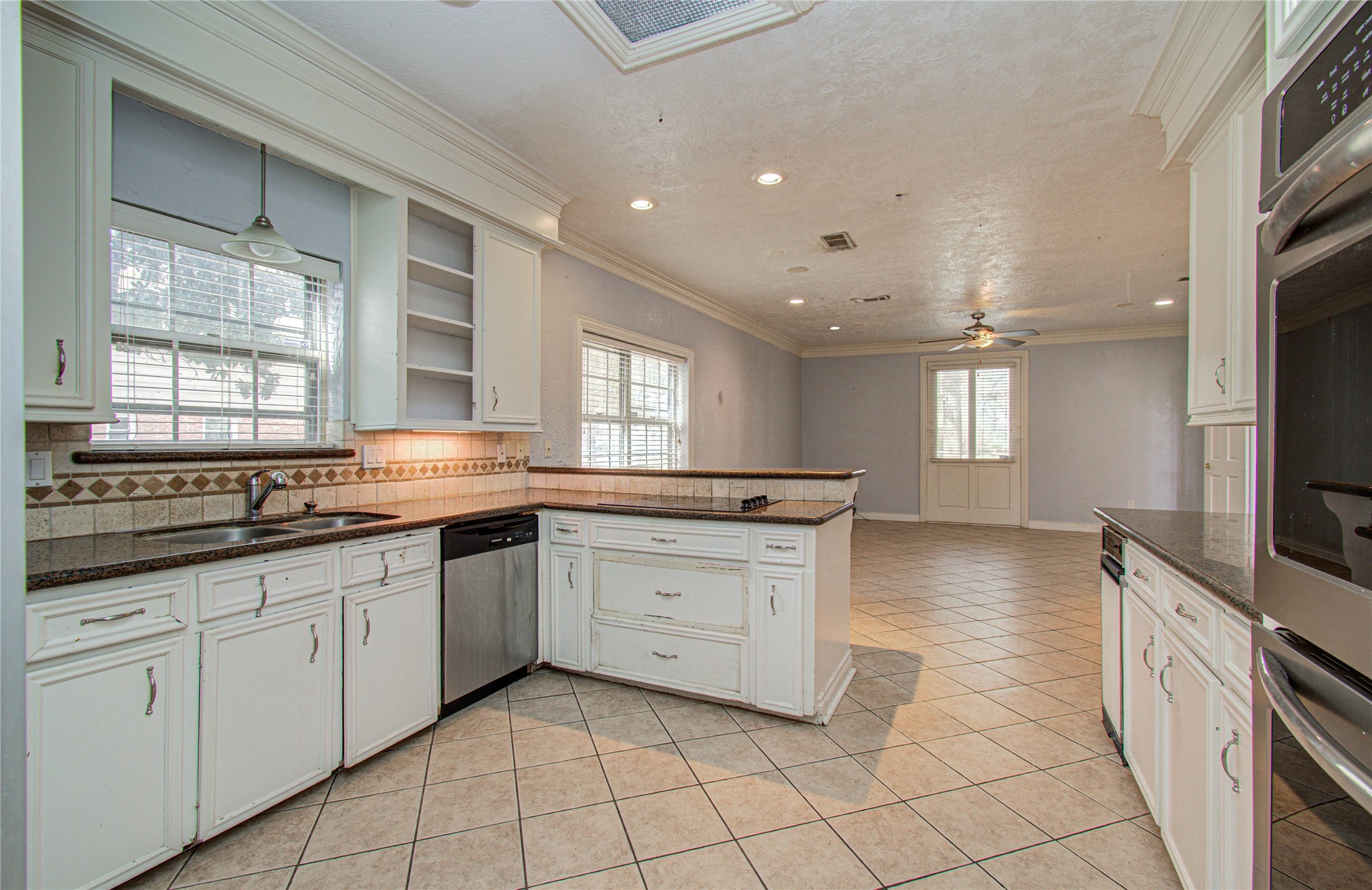 8103 Oak Moss Drive Spring, TX 77379 - Photo 17 of 33 a kitchen with granite countertop white cabinets and appliances