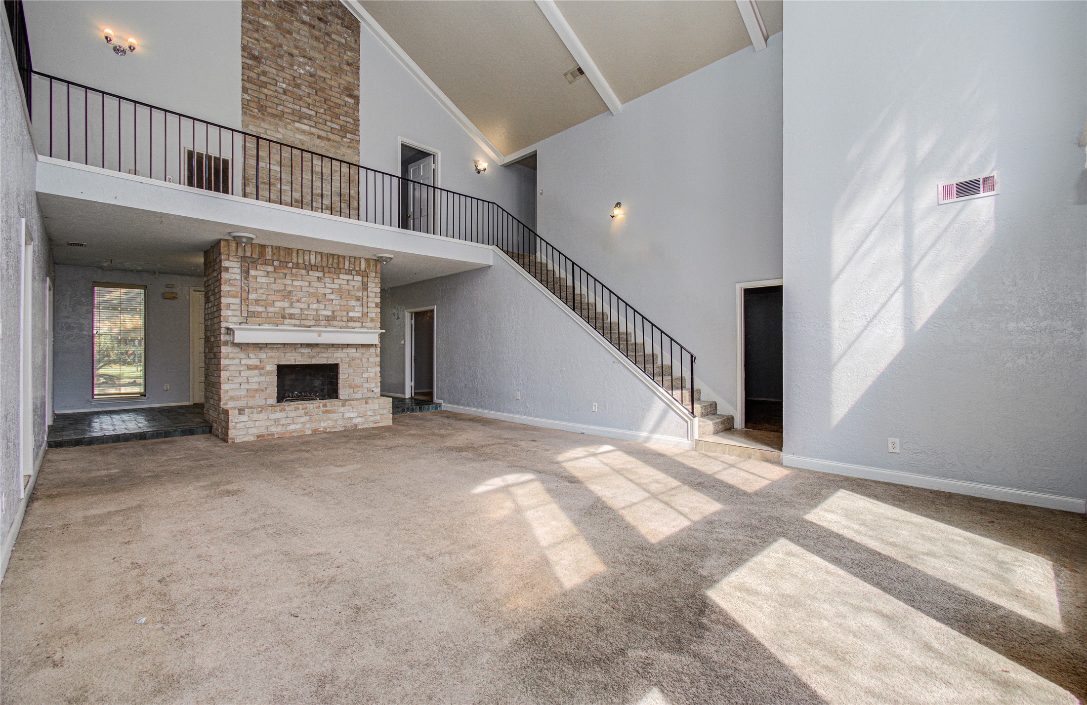 8103 Oak Moss Drive Spring, TX 77379 - Photo 25 of 33 a view of an empty room with wooden floor and a fireplace