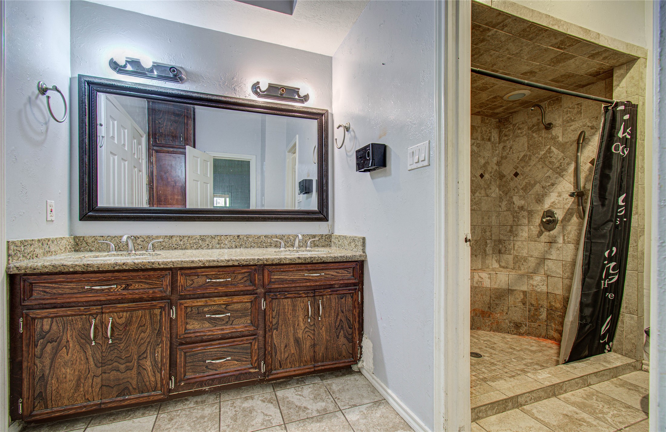 8103 Oak Moss Drive Spring, TX 77379 - Photo 30 of 33 a bathroom with a sink a mirror and a shower