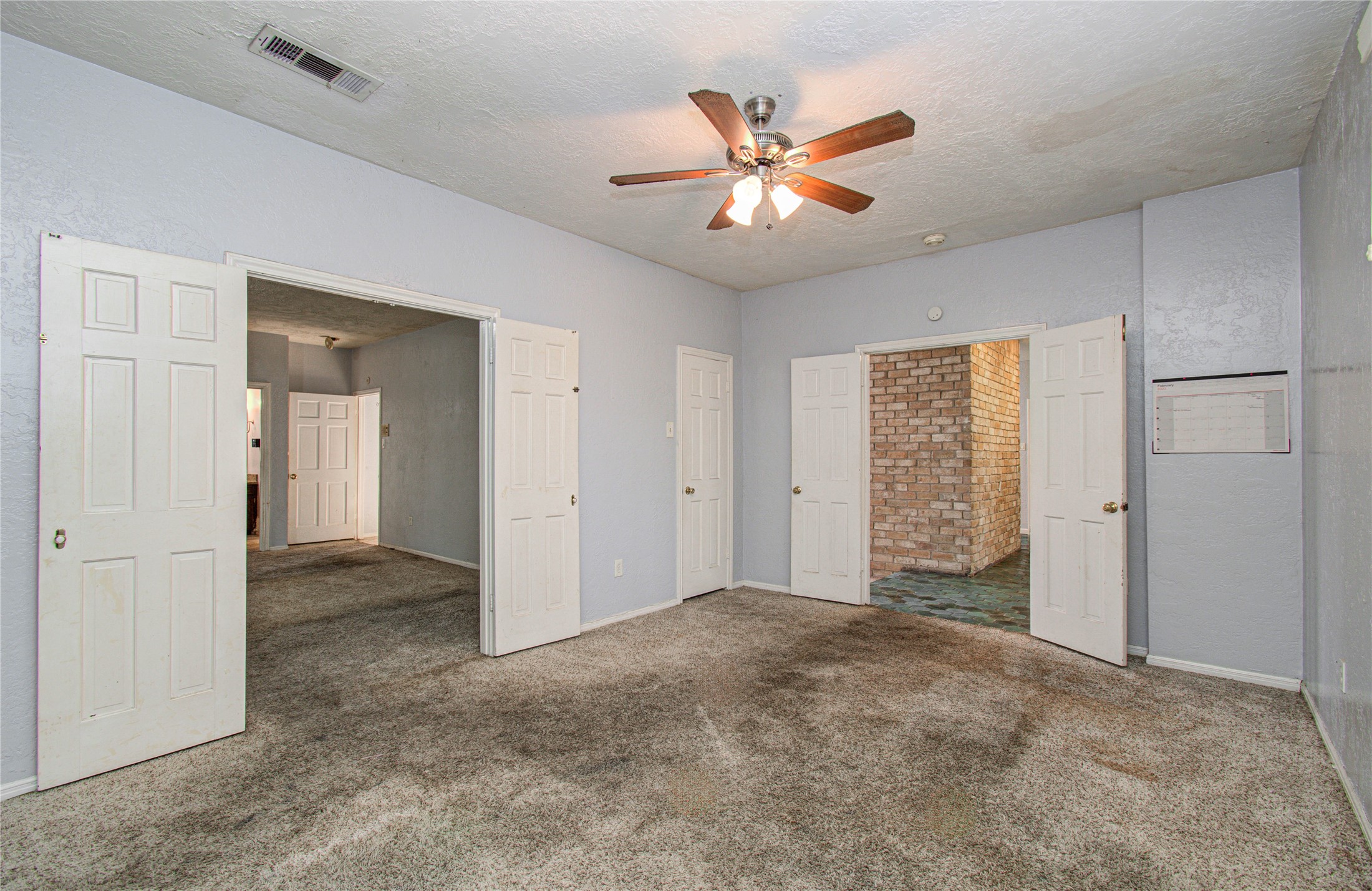 8103 Oak Moss Drive Spring, TX 77379 - Photo 33 of 33 an empty room with closet and a chandelier fan