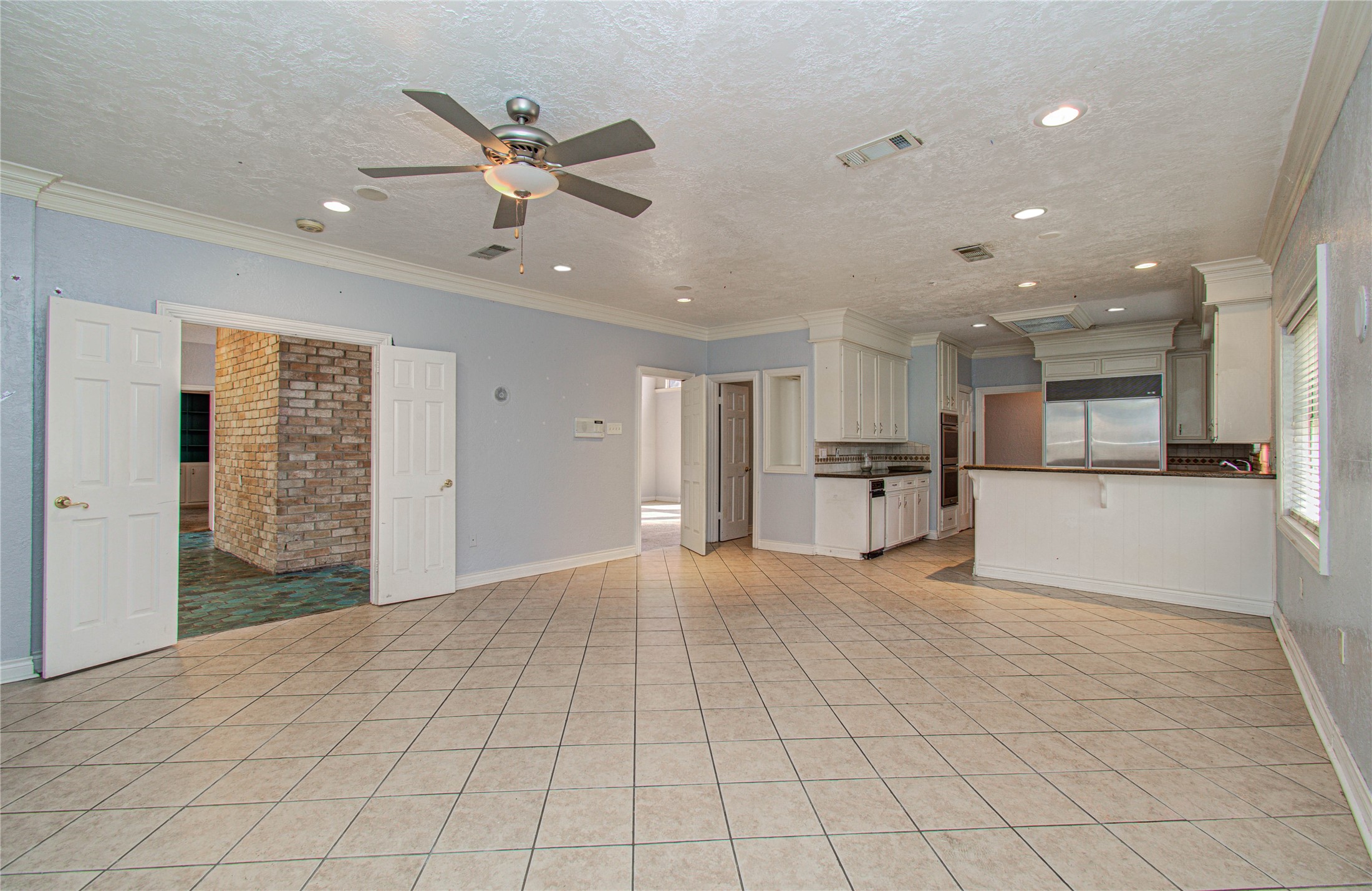 8103 Oak Moss Drive Spring, TX 77379 - Photo 10 of 33 a view of an empty room with kitchen view and a window