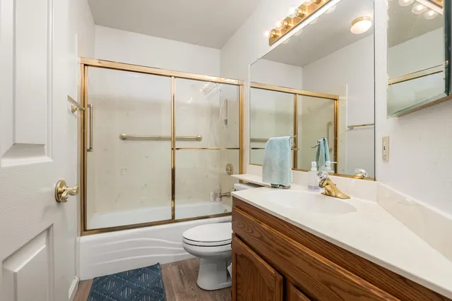 a bathroom with a sink toilet and shower