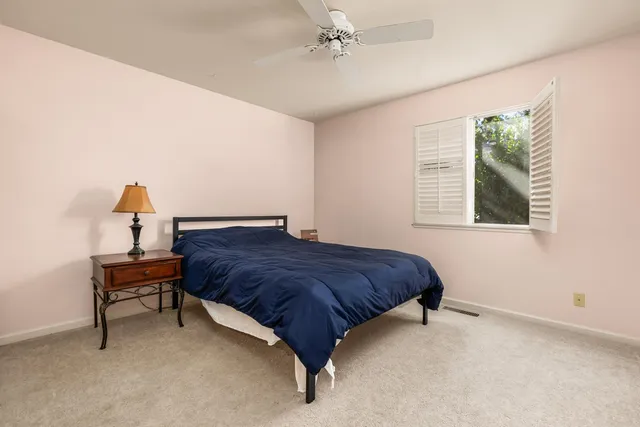 a bedroom with a bed and a table