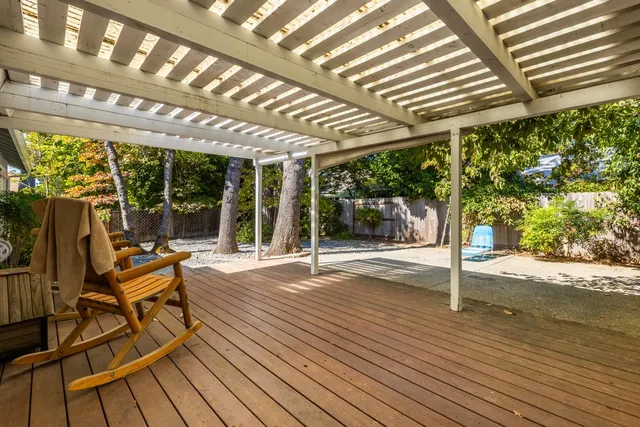 a view of a patio with table and chairs and wooden floor