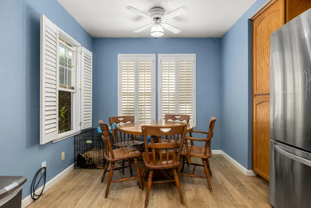 a view of a dining room with furniture and a window