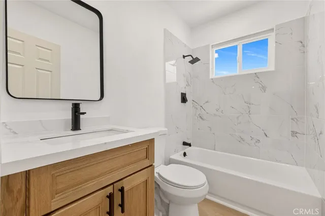 a bathroom with a sink a toilet and bathtub