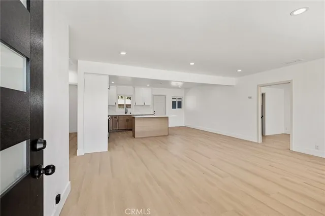 a view of a kitchen with a sink and a refrigerator