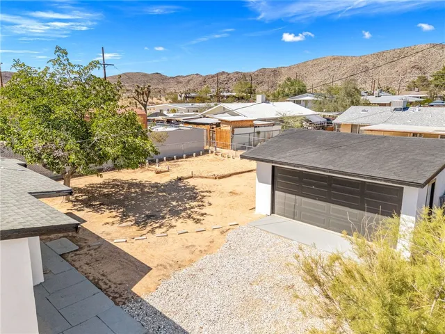 a view of a house with snow on the road