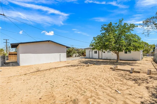 a view of garage with a refrigerator and a chair