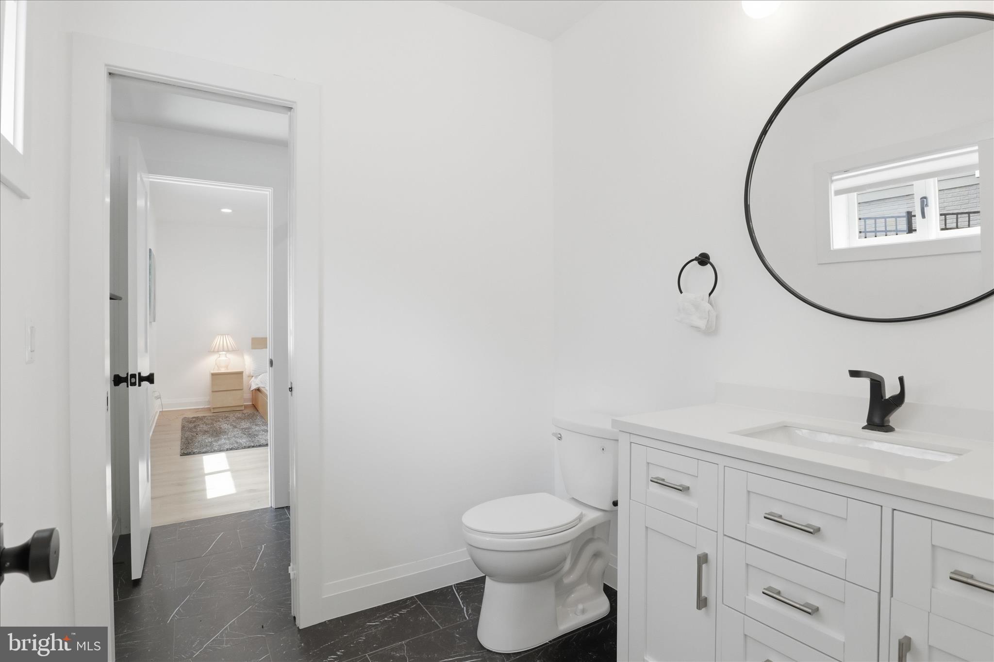 202 Branch Road Southeast Vienna, VA 22180 - Photo 50 of 59 a bathroom with a toilet a sink and mirror