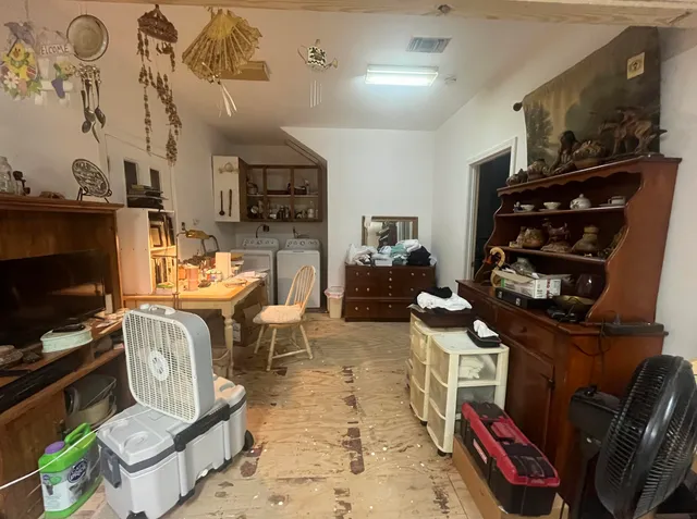 a bedroom with furniture and a flat screen tv