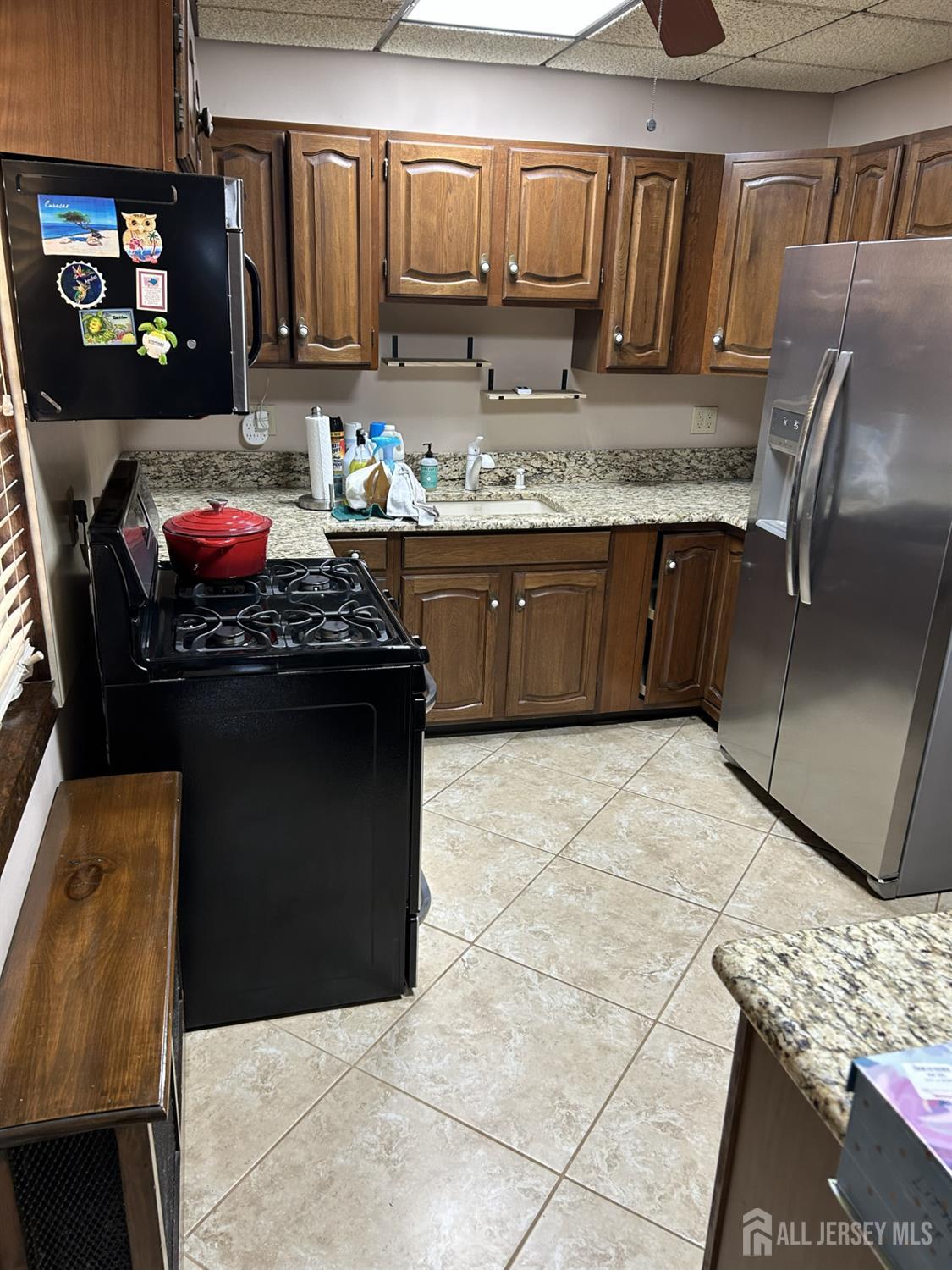 73 Edgar Street Carteret, NJ 07008 - Photo 3 of 5 a kitchen with stainless steel appliances granite countertop a sink stove and cabinets