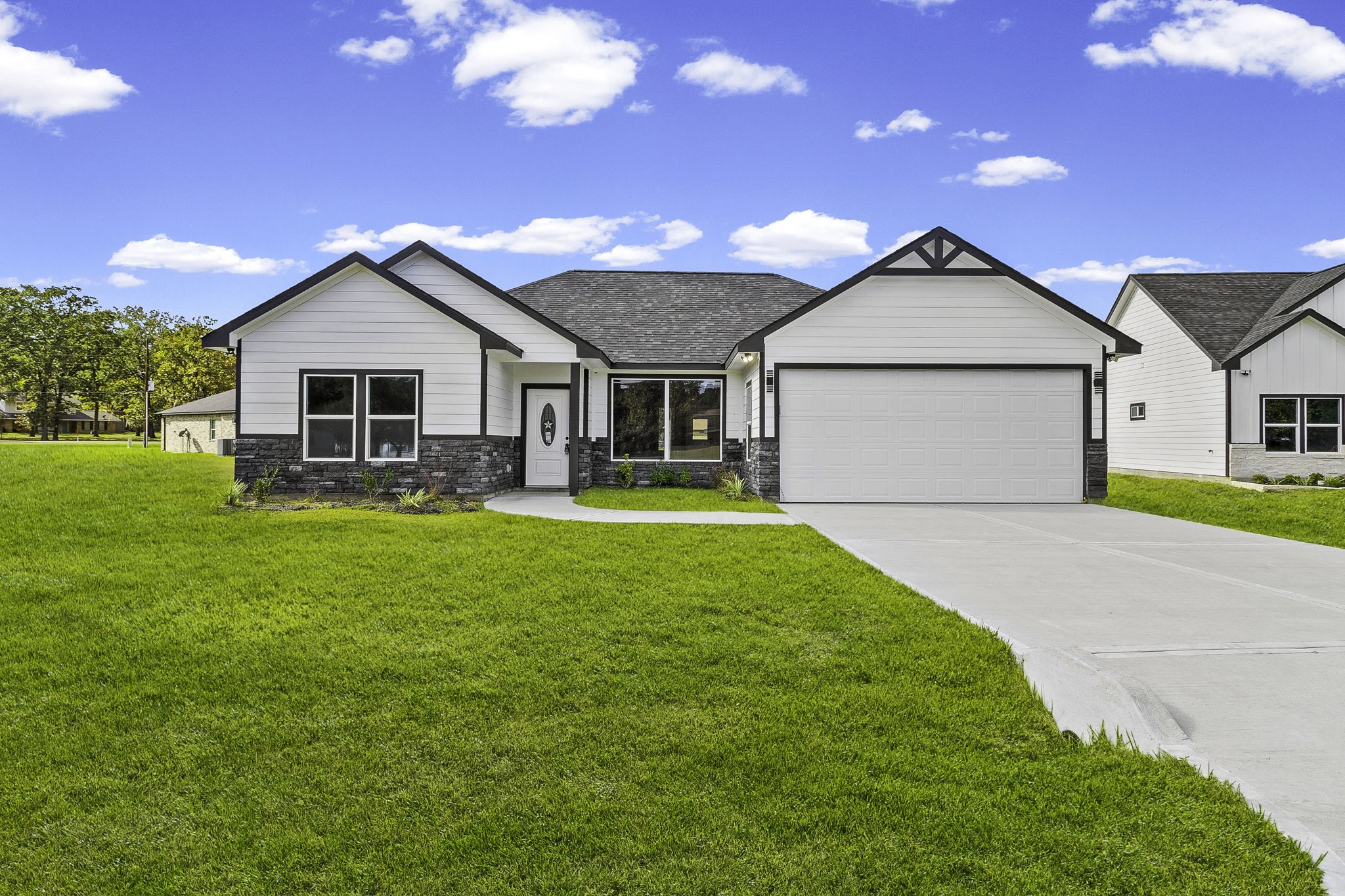 a front view of house with yard and green space