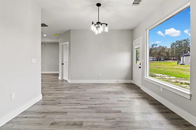 a kitchen with granite countertop white cabinets and stainless steel appliances