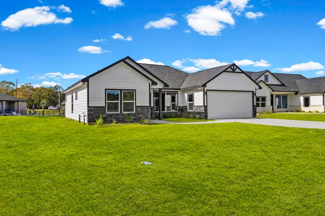 a front view of house with yard and green space
