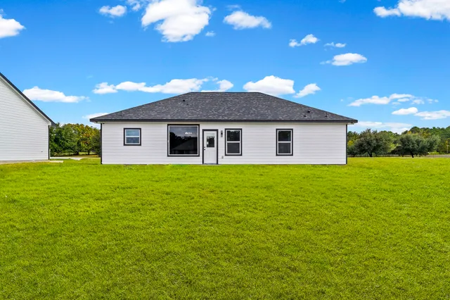 a view of a swimming pool with outdoor seating and yard