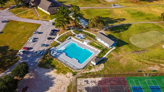 a view of a swimming pool with a yard