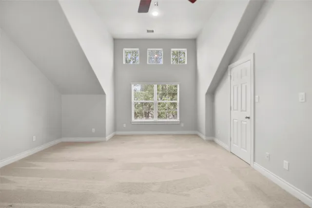 a view of an empty room with a ceiling fan