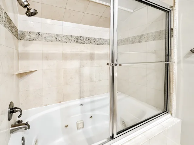 a bathroom with a granite countertop sink mirror and bathtub