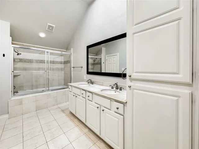 an empty room with a ceiling fan and a bathroom