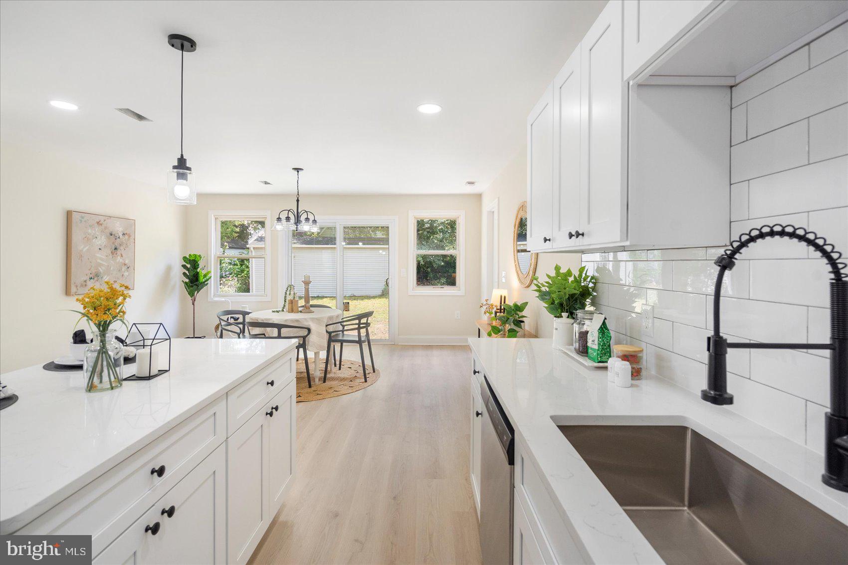 8111 Holly Road Curtis Bay, MD 21226 - Photo 18 of 46 a kitchen with a sink refrigerator and cabinets